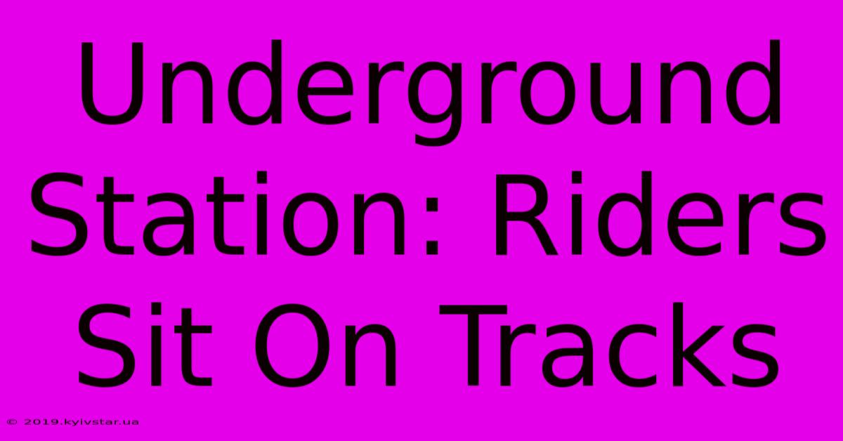 Underground Station: Riders Sit On Tracks